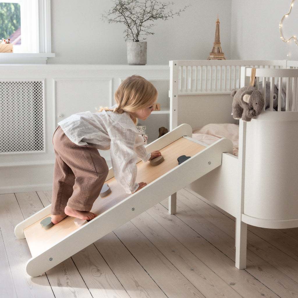Sebra Cot Bed Baby & Junior - Classic White - Child playing with Slide