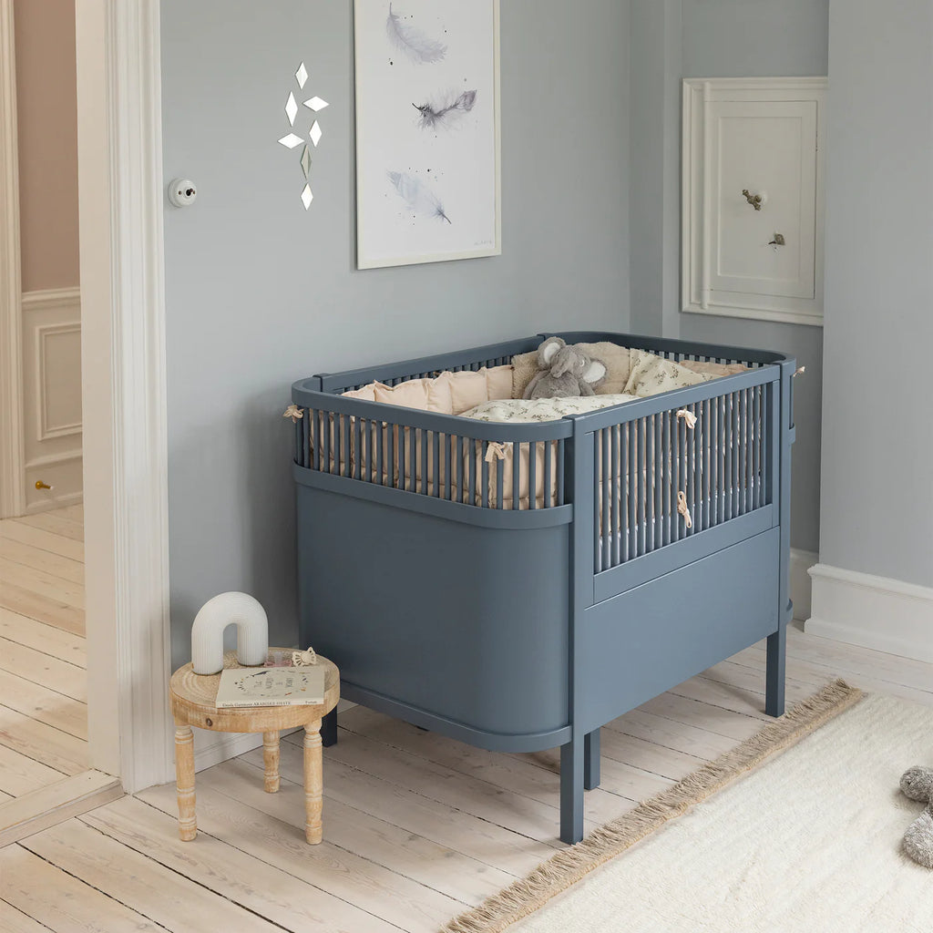 Sebra Cot Bed Baby & Jr. in Forest Lake Blue with raised newborn mattress base