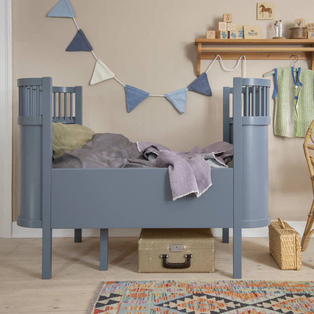 Scandinavian design Sebra Cot Bed in Forest Lake Blue styled in modern nursery